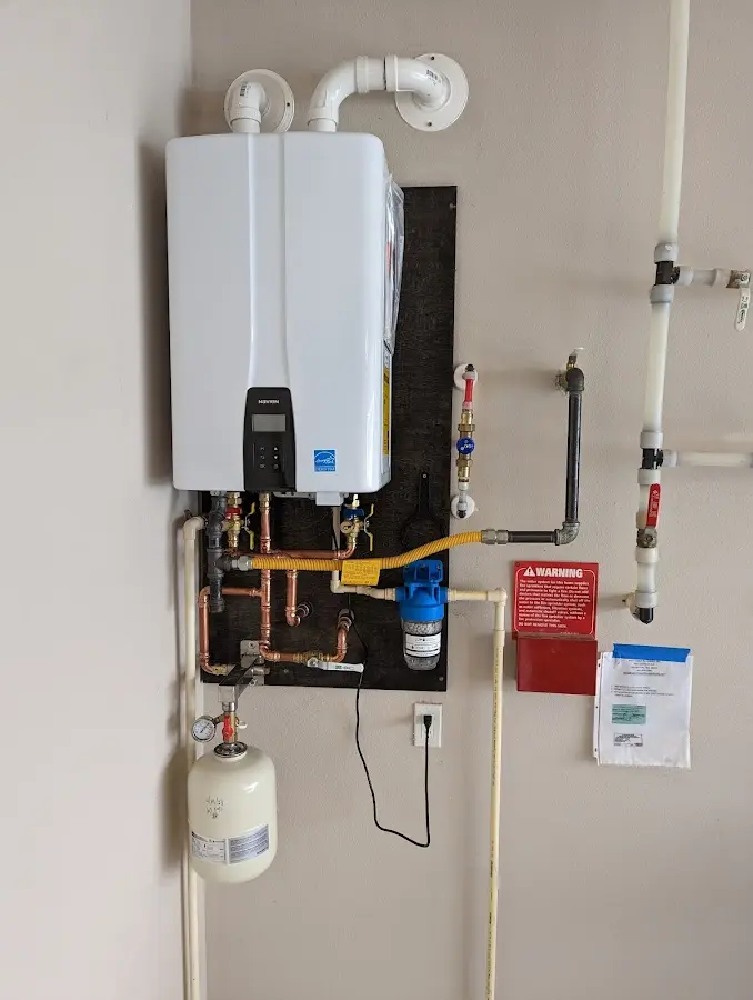 Professional plumber installing copper piping in a Collegeville home